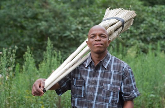 Stock photograph of a black South African entrepreneur small business broom salesman in Hilton, Pietermaritzburg, Kwazulu-Natal