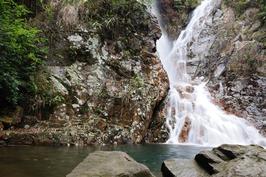 Flowing stream waterfall in China mountain areas