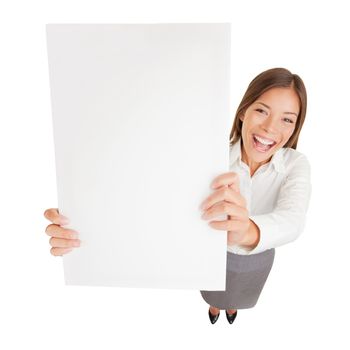 Businesswoman with blank sign excited. Fun high angle perspective of an attractive young happy cheerful businesswoman holding up a blank sign for your attention with copyspace for your advert or text isolated on white