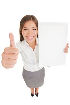 Businesswoman showing sign poster. Happy business woman giving thumb up holding an empty paperboard, with copyspace