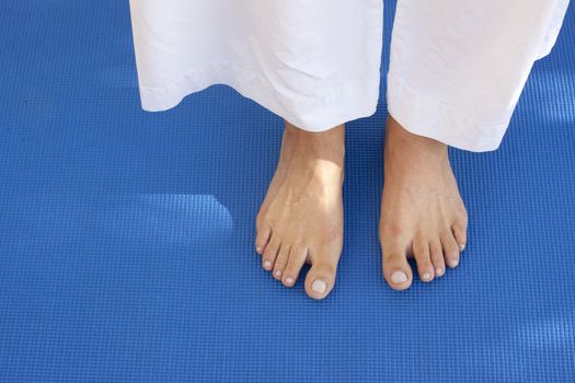 A womans feet on a training carpet. Space for text