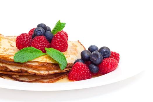 Delicious Freshly Prepared Pancakes with Honey and Berries on white background