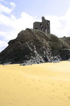 beach view of an old castle ruins in Ballybunion county Kerry Ireland