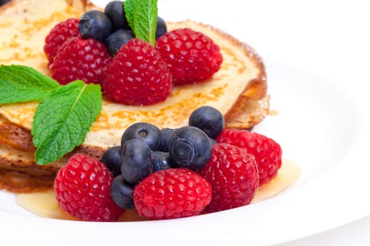 Delicious Freshly Prepared Pancakes with Honey and Berries on white background