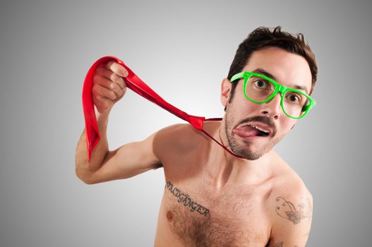 man who choking with tie on gray background