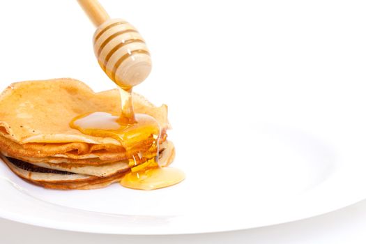 Delicious Freshly Prepared Pancakes with Honey on white