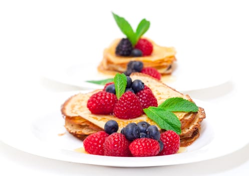 Delicious Freshly Prepared Pancakes with Honey and Berries on white background