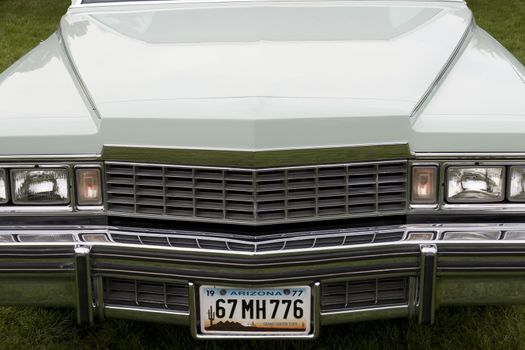the hood of a classic American car with an altered number plate