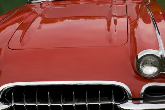 the hood of a classic red sports car