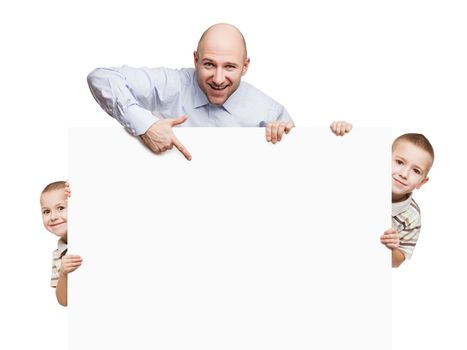 Smiling father and little sons holding blank sign or placard white isolated