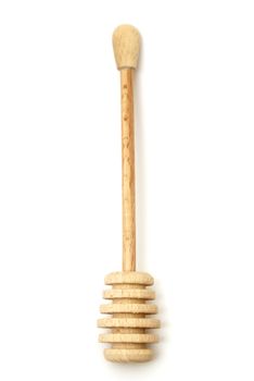 An overhead shot of a handmade wooden honey stick.