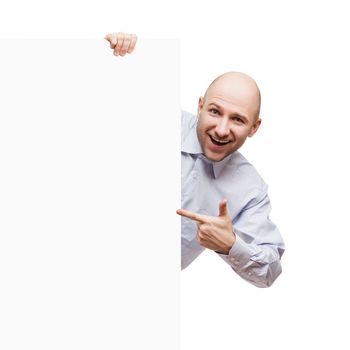 Handsome smiling bald or shaved head man holding blank sign or placard white isolated