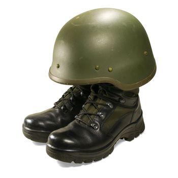 Soldier and army attributes: military boots and helmet. Isolated on white background. Clipping path.