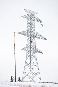Workers working high in a new electrical power line tower