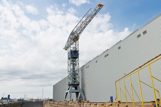 Crane near a covered dry dock at the shipyard