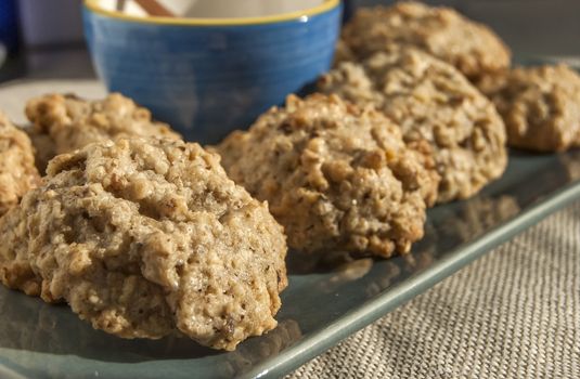 Homemade oatmeal cookies in plate and blue bowl