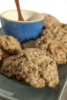 Homemade oatmeal cookies in plate and blue bowl