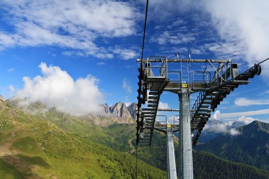 	summer landscape of Italian Dolomites with ski lifts on foreground