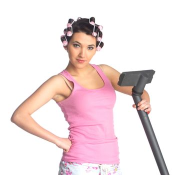 Funny girl with hair curlers on her head with vacuum cleaner isolated on white
