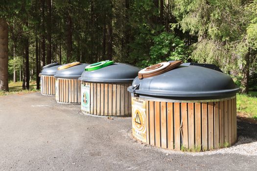 four wooden recycle bins for waste segregation 
