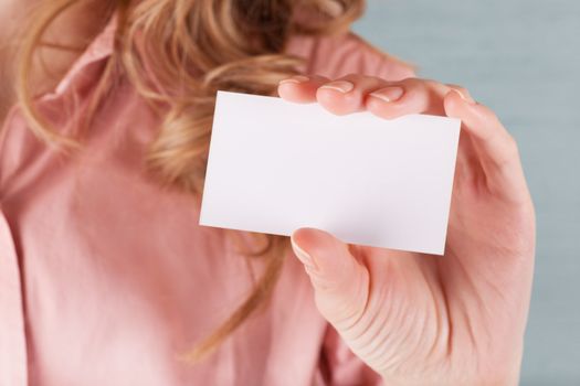 Image of business woman holding her visiting card