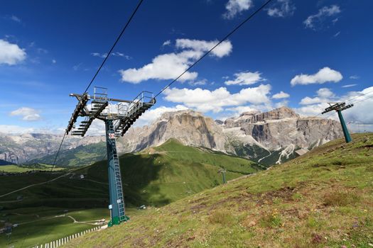 summer landscape of Italian Dolomites with ski lifts on foreground