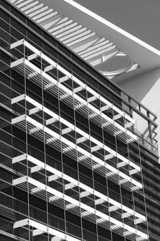 Modern architecture with glass of windows under blue sky.