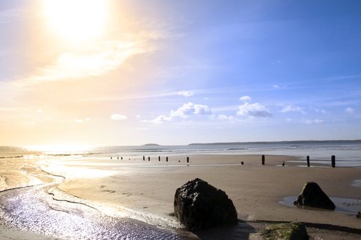 wave breakers at sunset on a golden beach in youghal county cork ireland