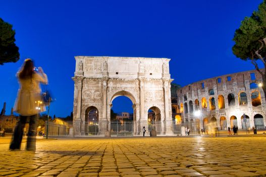 Night view of Colosseum and Constantine Arc with turist at Roma - Italy