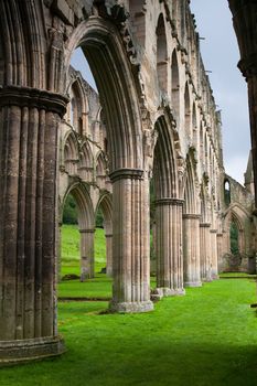 Scenic view of ruins of Rievaulx Abbey under cloudscape, North Yorkshire Moors, National Park, England