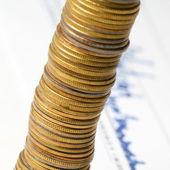 coins and financial graph on background