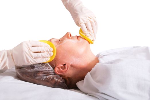 Beautician makes skin treatment woman in spa salon.