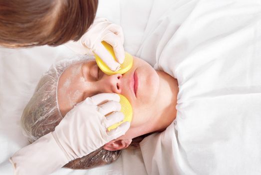 Young woman receiving spa treatments on the face.
