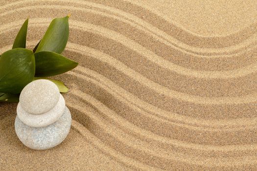 background with balance zen stones in sand and green leaves