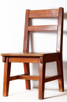 wood chair with white wall in background 