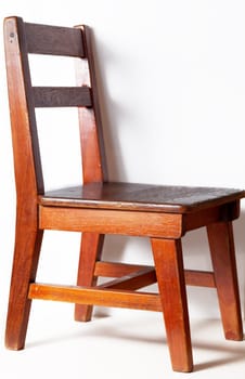 wood chair with white wall in background 