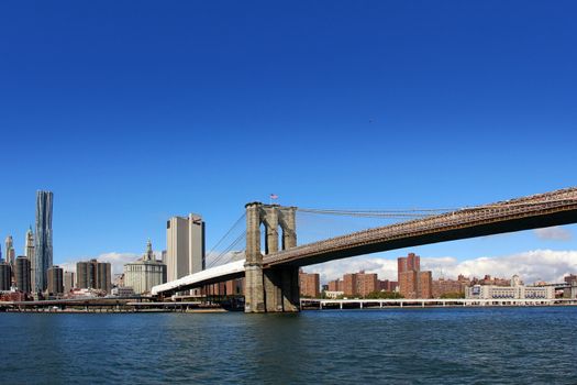 View from East River of the Brooklyn Bridge and skyline in New York City, New York