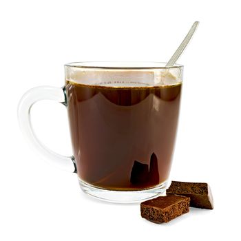 Coffee in a glass cup, a spoon, two slices of dark porous chocolate isolated on white background