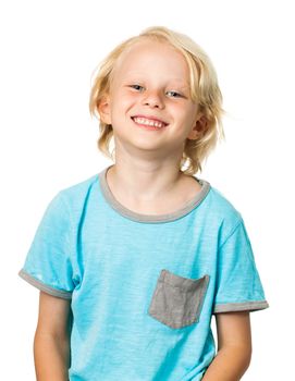Isolated portrait of a very cute happy young boy smiling and looking at camera.