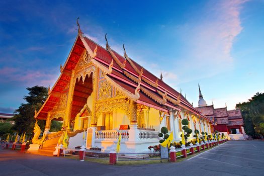Wat Phra Singh temple at sunset in Chiang Mai, Thailand. 