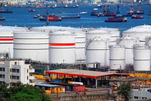 Oil tanks and ship at day
