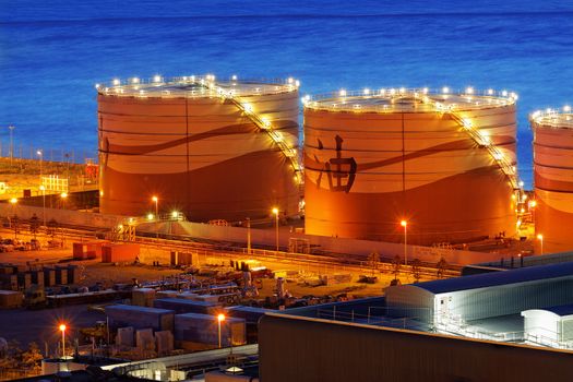 Oil and gas refinery at twilight - Petrochemical factory, chinsese oil word on tank
