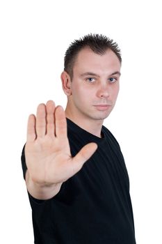 young man with blue eyes makes stop gesture / holds up hand - isolated on white background