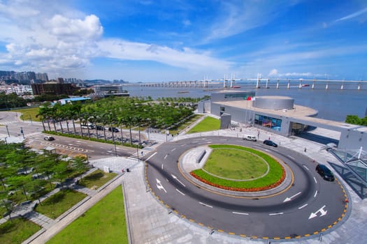 street view with skyscrapers, roundabout and blue sky. 