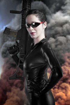 Sexy brunette woman in latex jumpsuit with heavy gun over smoke background