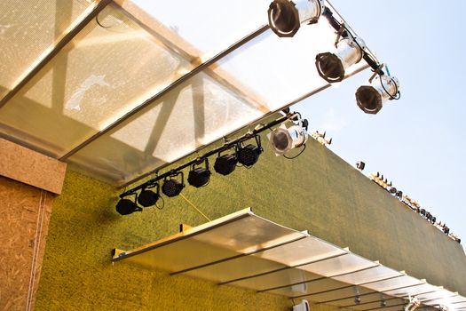 Spotlights mounted on the building. The sky in the background.