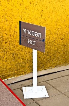 Exit signs. Mounted on white steel poles.