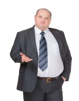 Obese businessman in a suit and tie standing facing the camera making a point with one hand in his pocket while gesturing with the other, isolated on white