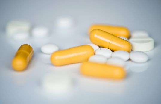 closeup photo of yellow and white pills