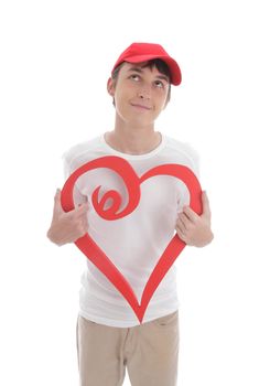 Daydreaming teenage boy holding a red valentine love heart.   Space for copy or message.